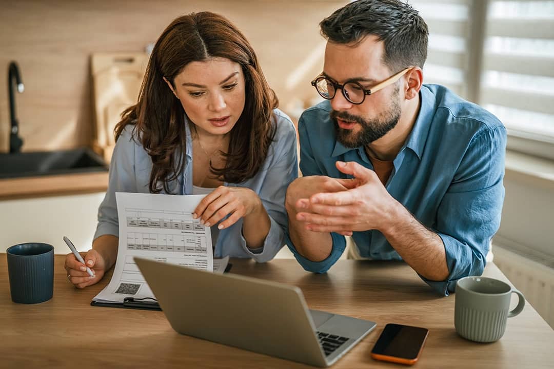A young couple discussing management of finances.